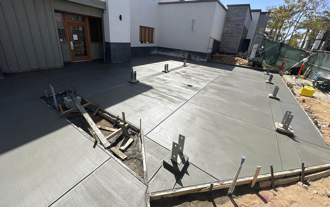 A house entrance of concrete driveway installation with lines finishes in Los Angeles